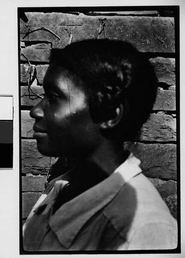 [Woman (Left Profile) Before Brick Wall]
