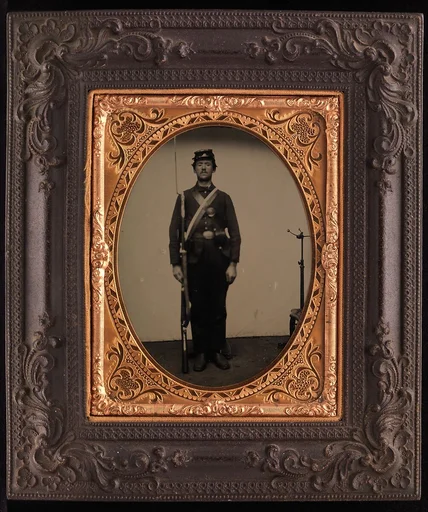 [Union Soldier Holding Rifle, with Photographer's Posing Stand]