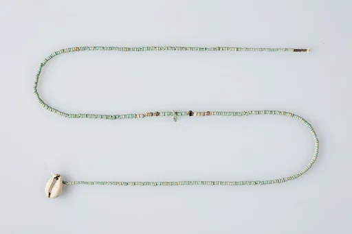 String of beads with shell pendant