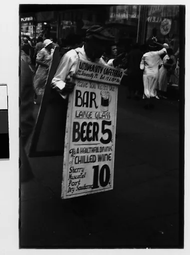 [Two 35mm Film Frames: Man Wearing Sandwich Board Advertisement, Fourteenth Street, New York City]