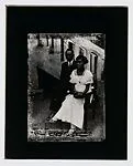 Stylish couple seated before stairs — Alex Agbaglo Acolatse