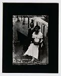 Stylish couple seated before stairs