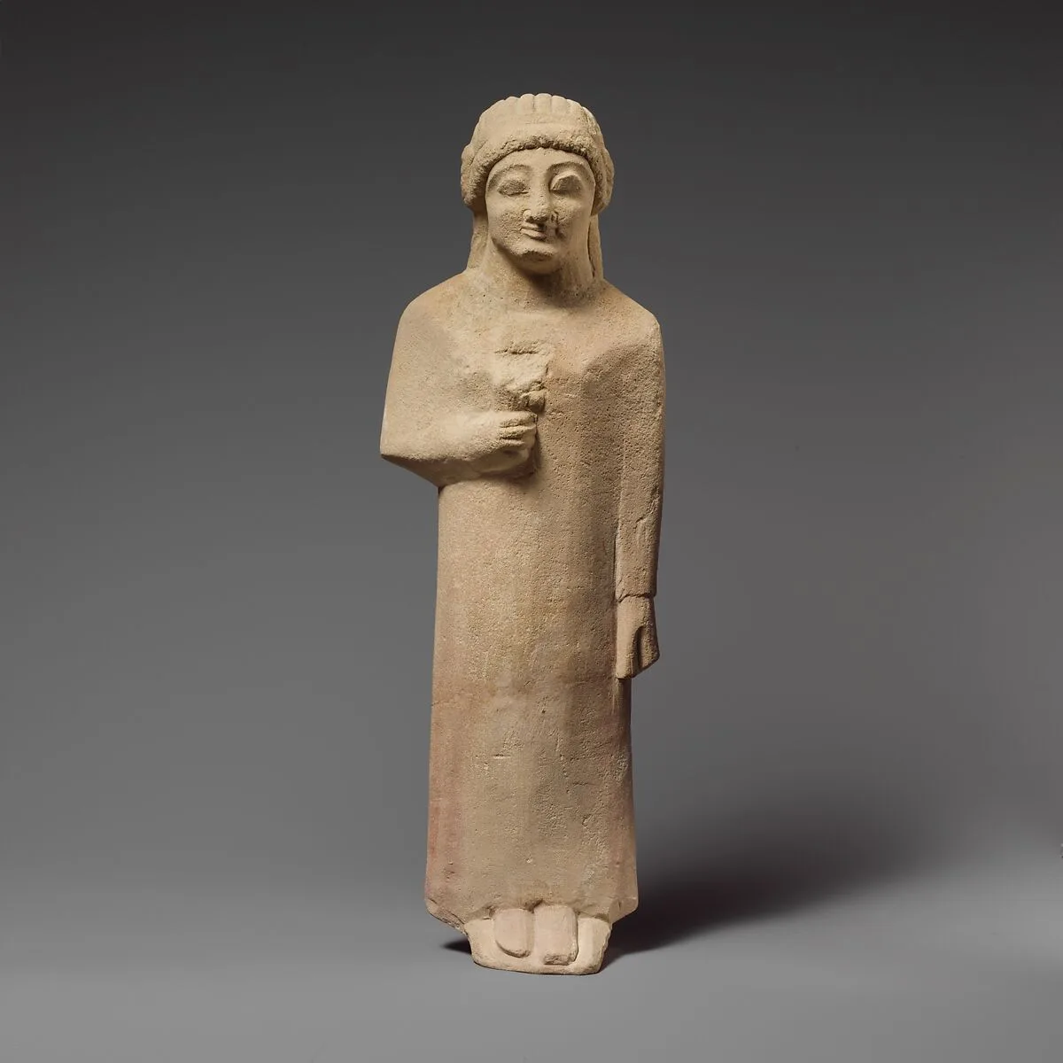 Limestone statuette of a female votary holding a flower — Unknown