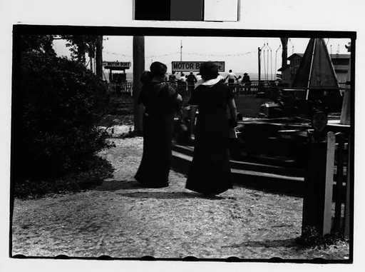 [Two 35mm Film Frames: Women and Children at Amusement Park Ride, From Behind]