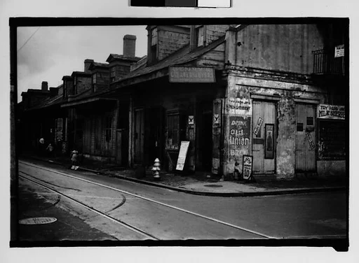 [Row of Shuttered Houses with Corner Laundry in French Quarter, New Orleans, Louisiana]