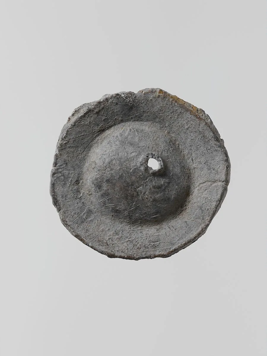 Lead disk with a hole in the center — Unknown