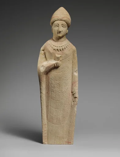 Limestone statuette of a female votary holding a flower