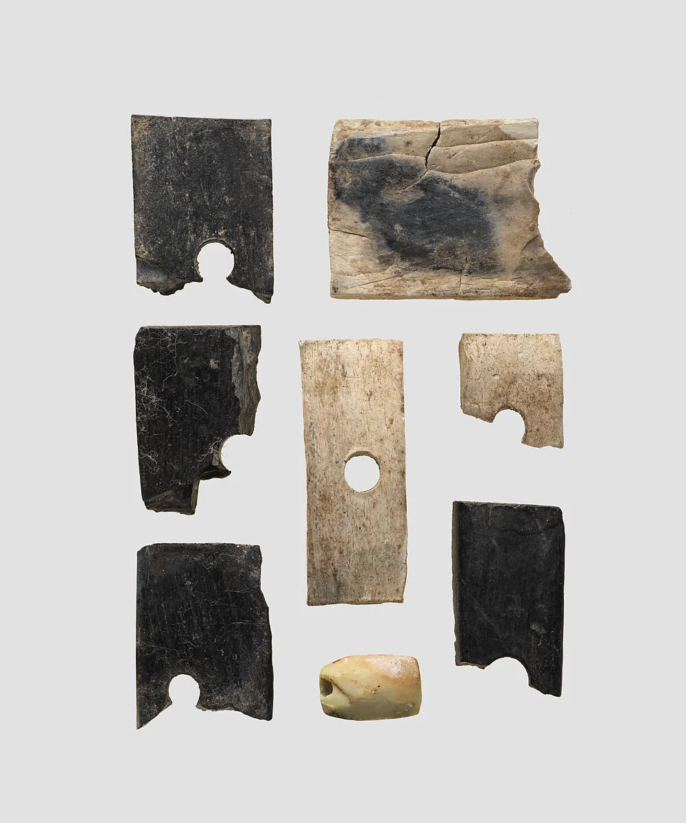 Pieces of inlay and bead — Unknown
