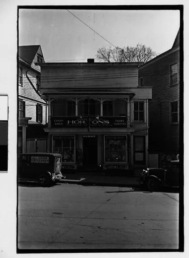 [Three 35mm Film Frames: Saake's Drugstore, Probably Millerton, New York; Partial View of Farm Buildings and Street, New York State; Parked Car on Main Street, New York State]