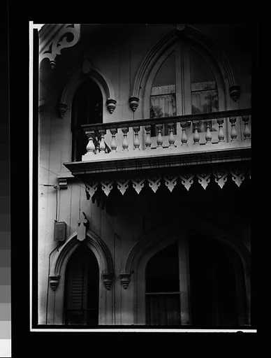 [Pointed-Arch Windows and Balcony Trim of Gothic Revival House]