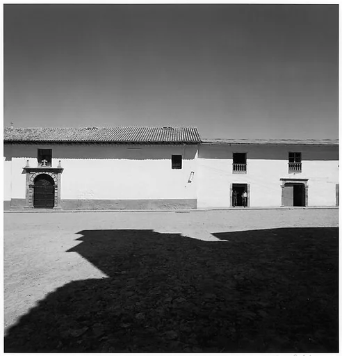 [Shadowed Plaza with Men in Doorway of Stone Building, Possibly Peru]