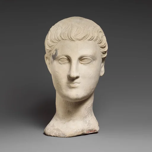 Limestone funerary bust of a beardless man