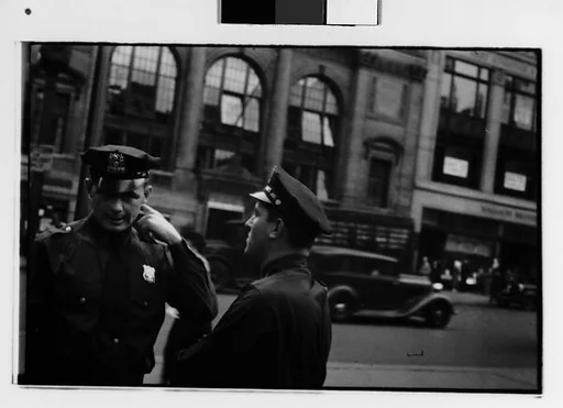 [Two 35mm Film Frames: Two Policemen in Conversation on Street, New York City]