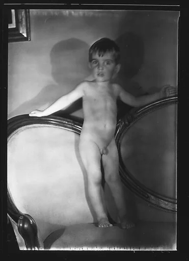 [Unidentified Naked Child Standing on Couch]