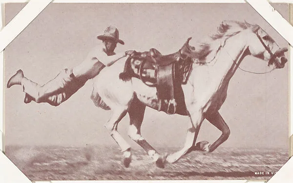 Cowboy hanging on back of saddle of white horse from Indians and Western Historical Scenes series (W417) — Unknown