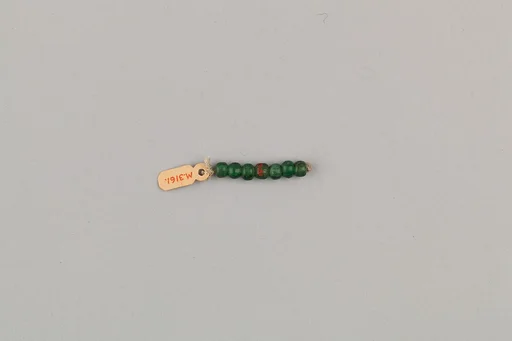 String of 7 elongated disc beads