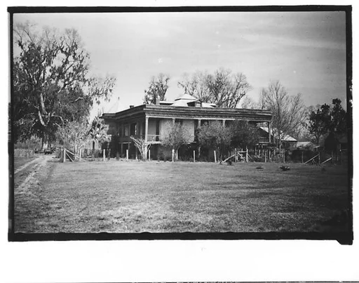 [Dilapidated House with Surrounding Full-Façade Porch, From Automobile, Louisiana]