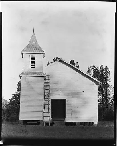 [Wooden Church with Adjacent Belltower and Ladder on Façade]