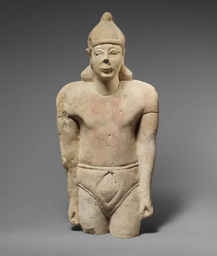 Limestone statuette of a male votary with Cypriot shorts and an Egyptian crown