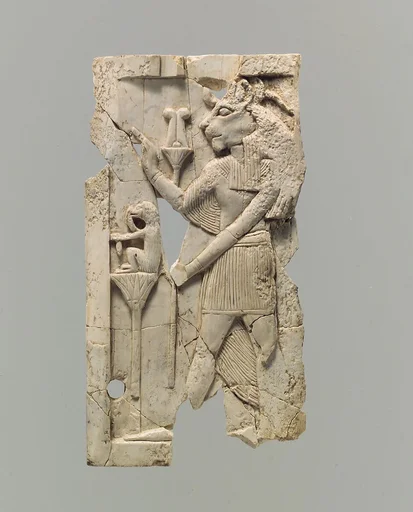 Furniture plaque carved in relief with lion-headed figure