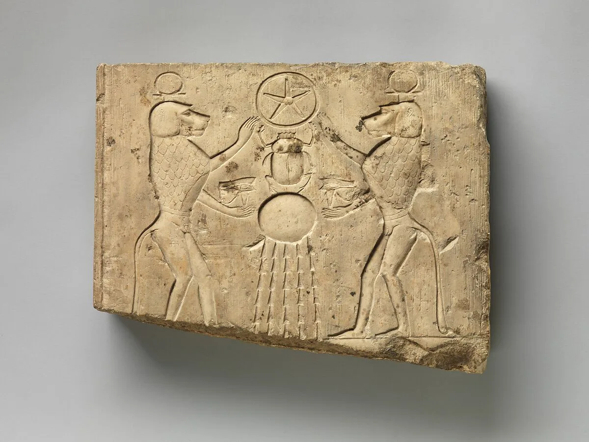 Relief panel showing two baboons offering the wedjat eye to the sun god Khepri, who holds the Underworld sign — Unknown