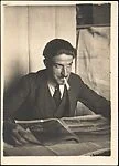 [André Maury Seated at Table with Cigarette and Newspaper]