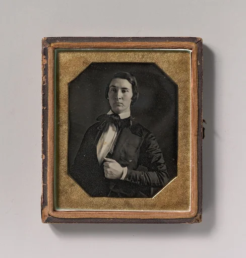 [Young Man Holding Jacket Lapel]