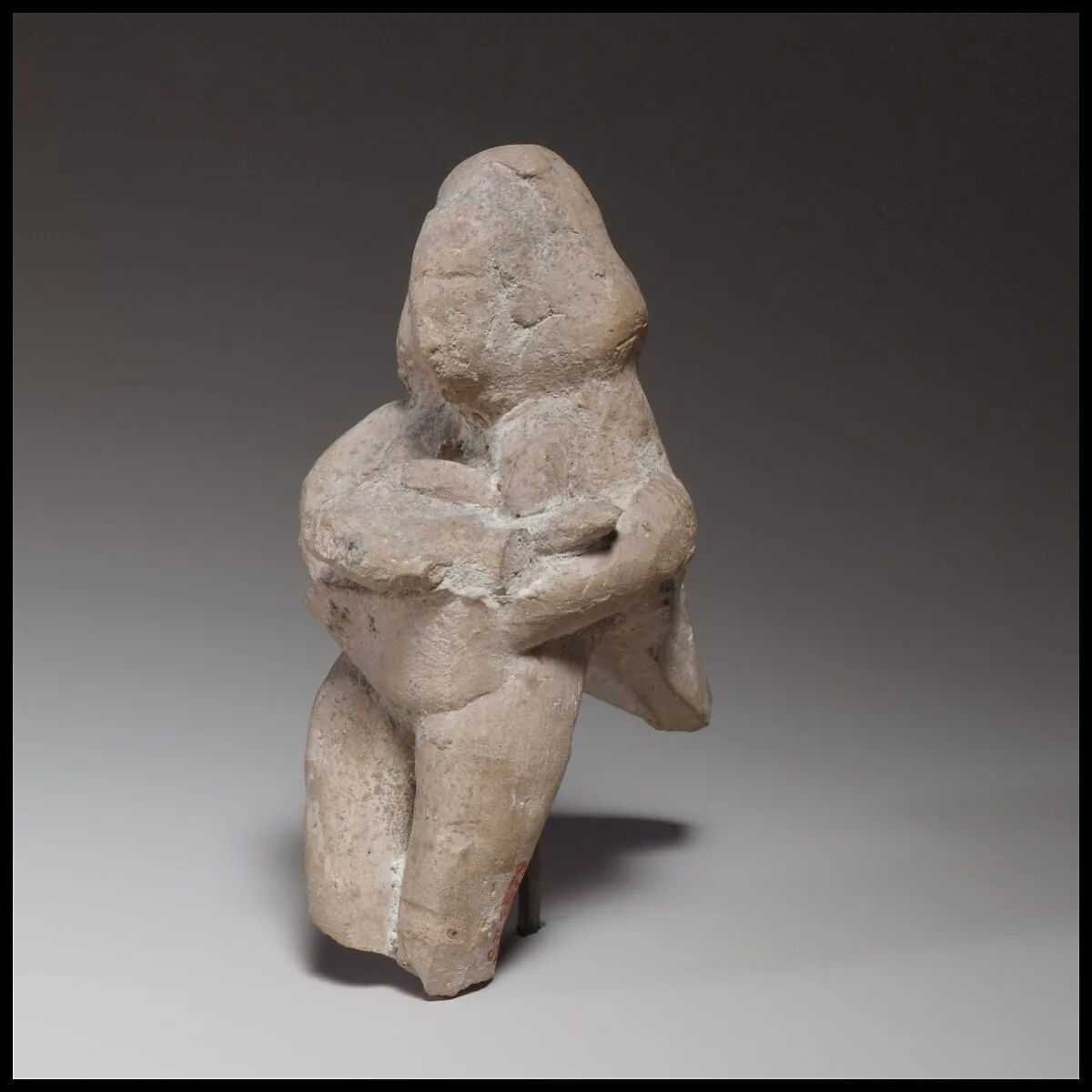 Seated female figurine — Unknown