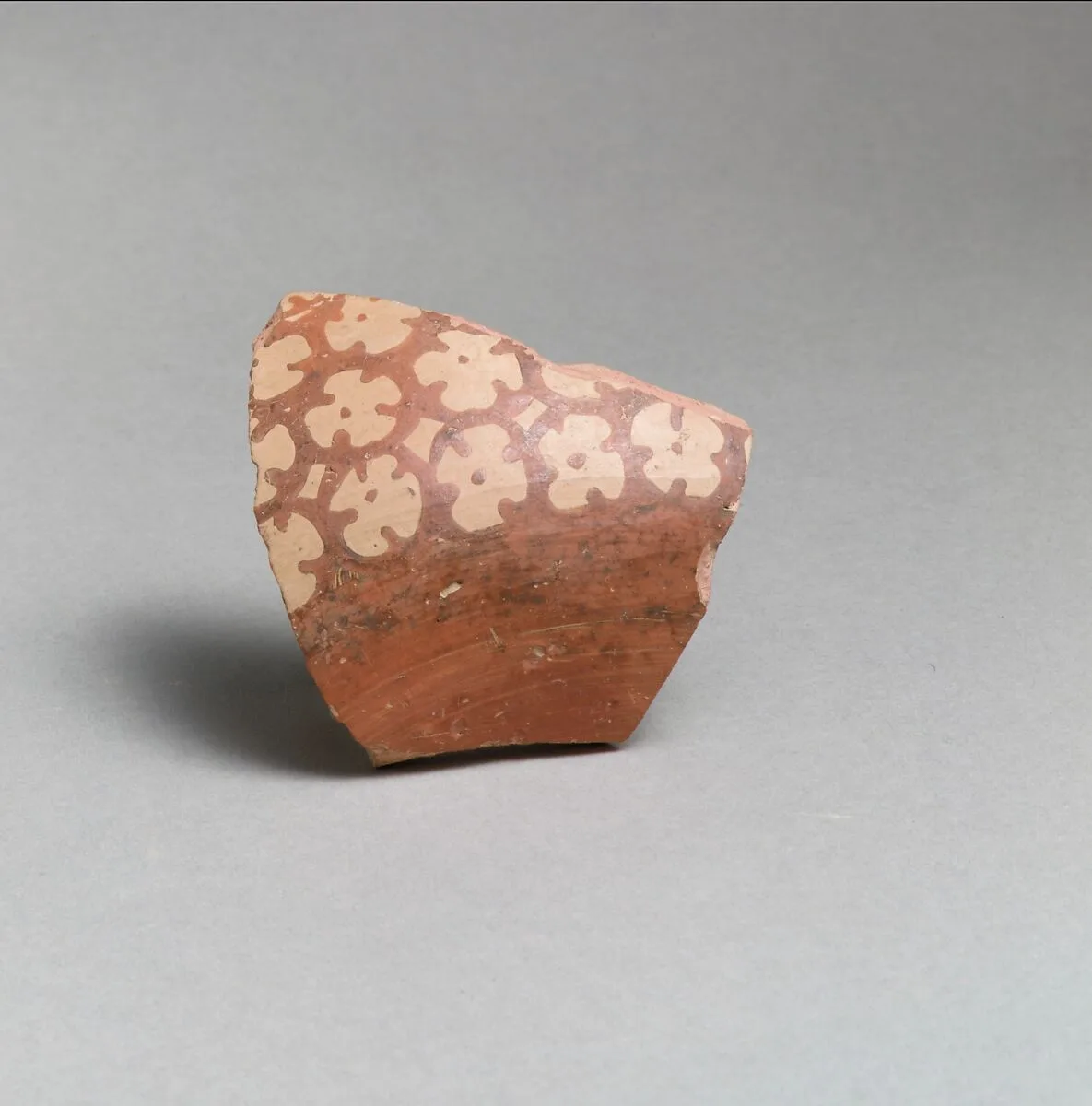 Terracotta vessel fragment with rosettes — Unknown