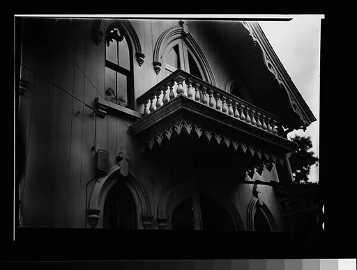 [Pointed-Arch Windows and Balcony Trim of Gothic Revival House]