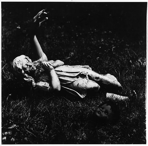 [Praying Female Statuette on Ground Next to Mannequin Arm and Doll Head]