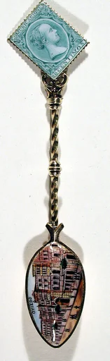 Souvenir spoon with street scene in Oviedo and finial in form of a postage stamp