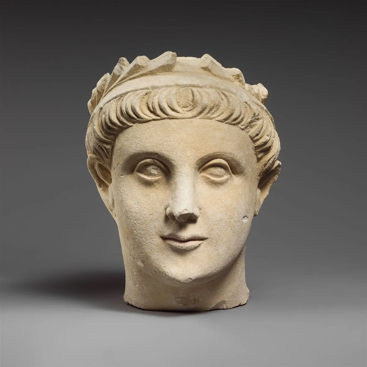 Limestone head of a wreathed youth — Unknown