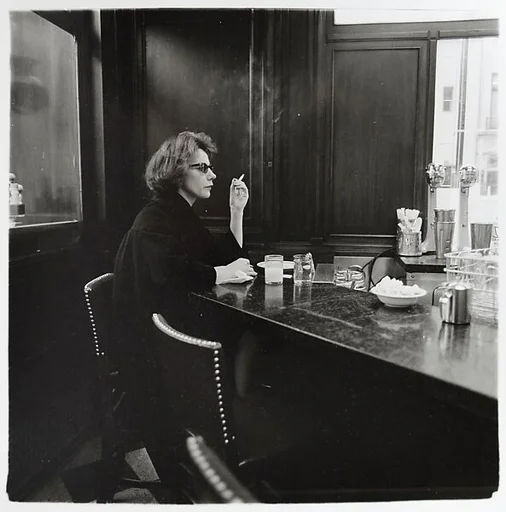 Woman at a counter smoking, N.Y.C.