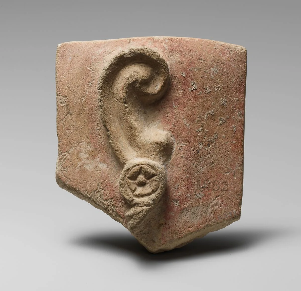 Stone votive relief of an ear with earring — Unknown