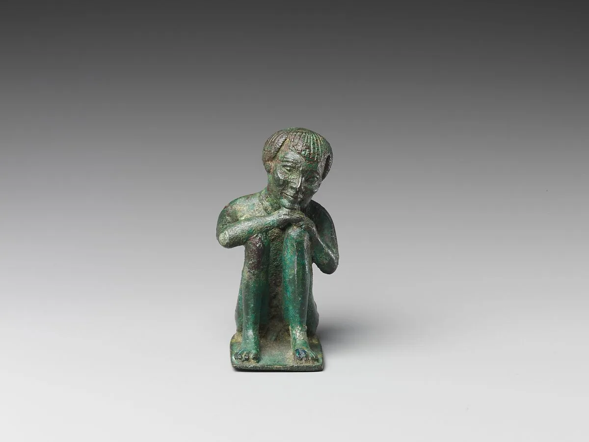 Man squatting with head resting on his hands on his knees — Unknown