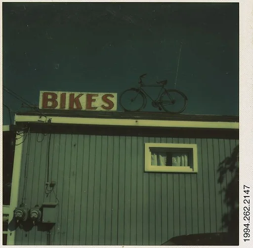 [Sign: "Bikes" and Bicycle on Roof]