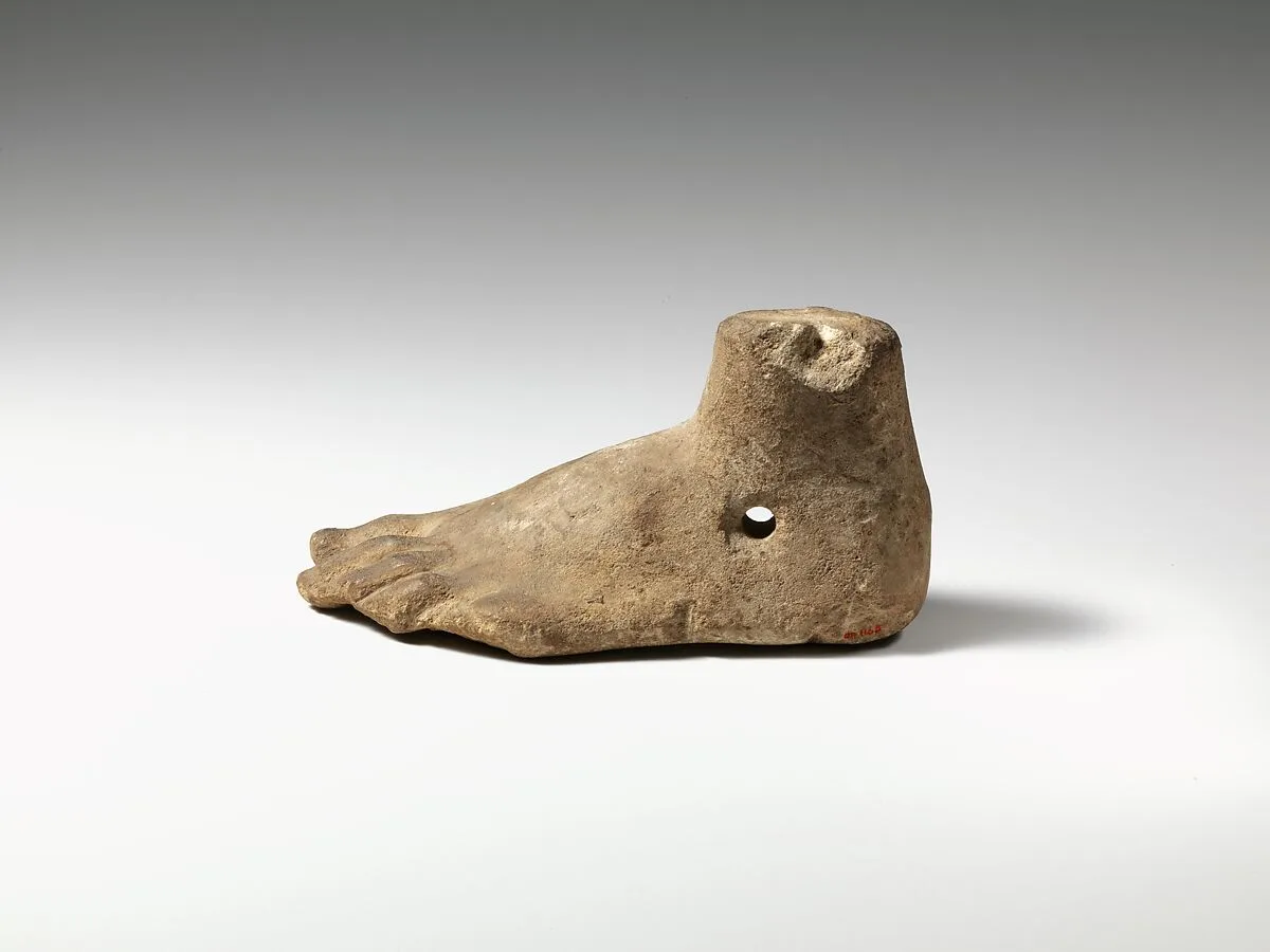 Limestone foot (left) with suspension hole — Unknown