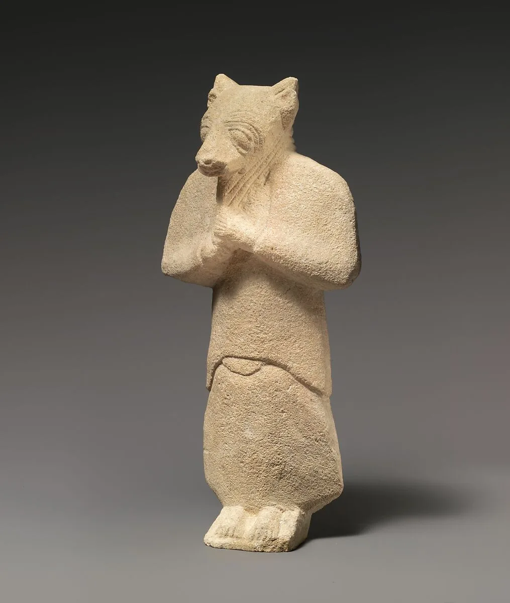 Limestone figure wearing a mask — Unknown