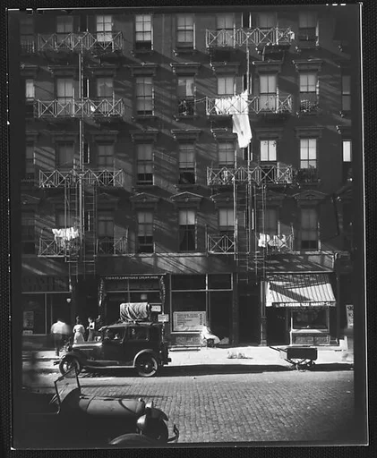 [Apartment Building with Ground Floor Shops and Parked Cars in Front, 41-43 Carmine Street, New York City]