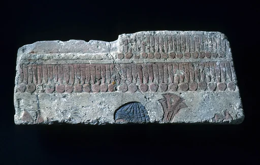 Relief with man carrying papyrus bundle