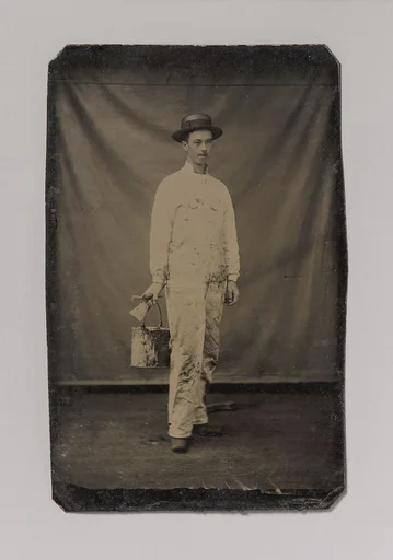 [Painter in Paint-spattered Overalls with Brushes and Paint Can]