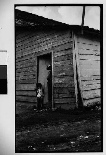 [Man and Child in Shanty Doorway, Cuba]