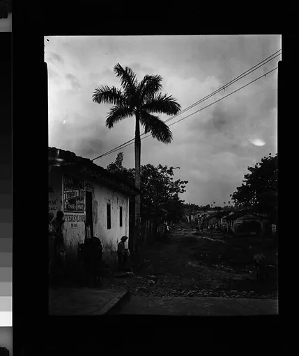 [View Down Dirt Road with People and Donkey in Foreground, Cuba]