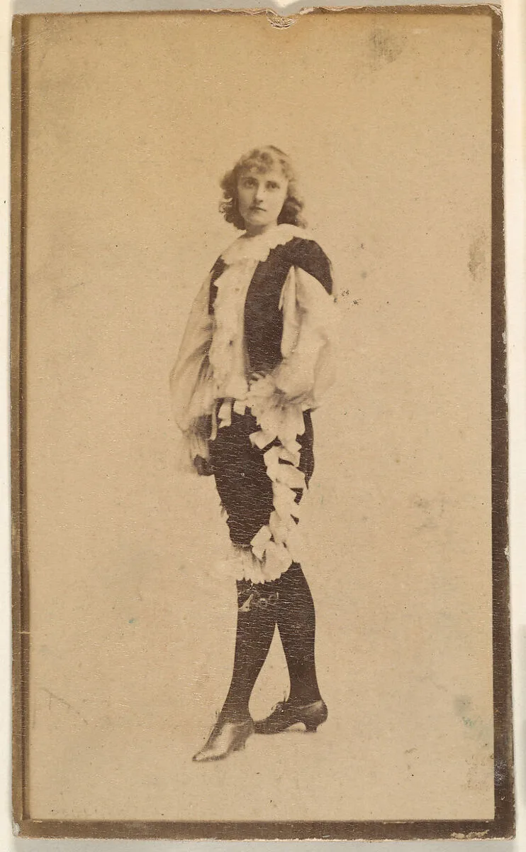 Actress wearing costume with ruffled blouse and trousers, from the Actresses series (N668) — Unknown