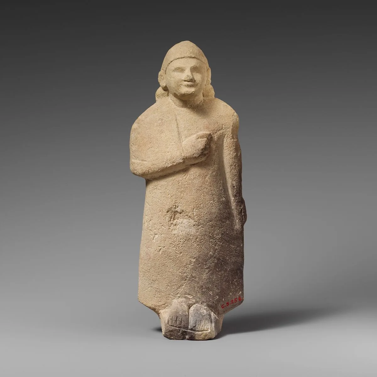 Limestone statuette of a beardless male votary with a conical helmet — Unknown
