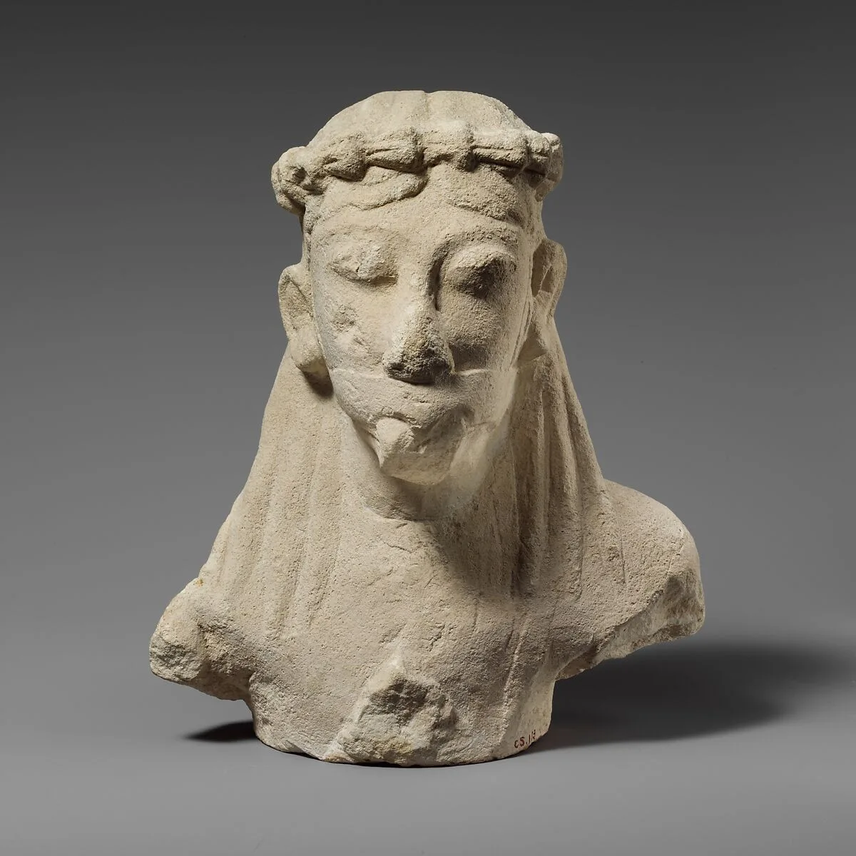 Upper part of a limestone statuette of a male aulos player — Unknown