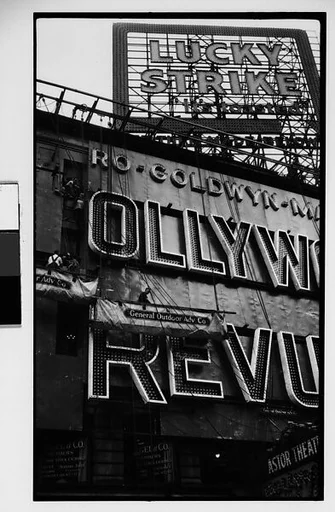 [Workers Mounting Neon Sign for "Hollywood Revue of 1929", Times Square, New York City]