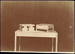 [Two Boxes on Table (Devices Used as Evidence of Movement)]