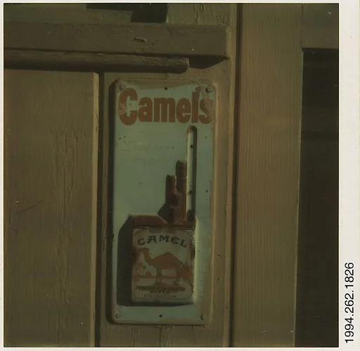 [Metal Cigarette Advertisement: "Camels"]